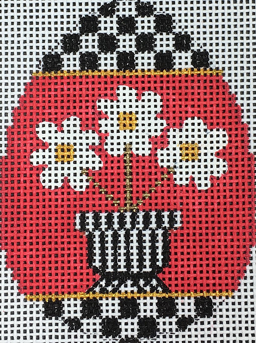 Amanda Lawford bright mod Easter egg needlepoint canvas of white flowers with a black and white checked border - part of a series of black and white patterned eggs