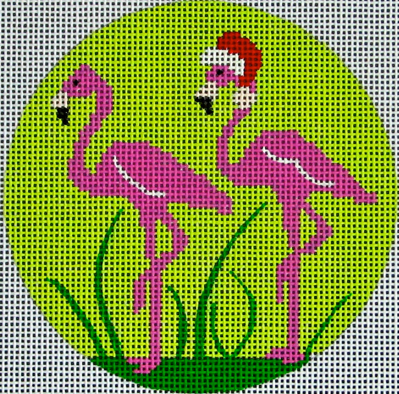 DC designs round Christmas ornament needlepoint canvas of two flamingos with a Santa hat on a tropical green background