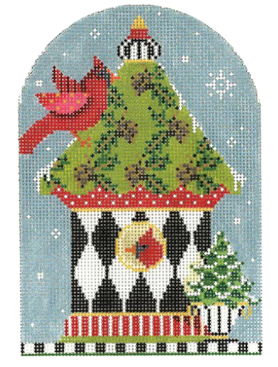 Kelly Clark winter and Christmas needlepoint canvas of a black and white harlequin birdhouse with two cardinals and a Christmas tree in the snow