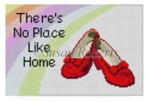 Susan Robert needlepoint canvas for a sign saying "there's no place like home" with a rainbow and a pair of ruby slippers from the Wizard of Oz