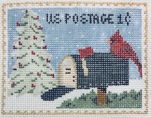 Plum Stitchery needlepoint canvas of a vintage-style postage stamp of a mailbox with a cardinal on top and a snow-covered pine tree in the background