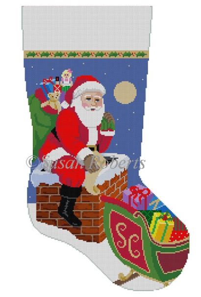 Susan Roberts Christmas stocking needlepoint canvas of Santa Claus entering the chimney of a snow-covered house with his bag of toys and his sleigh full of presents
