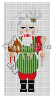 Susan Roberts needlepoint canvas of a chef nutcracker wearing a toque or chef's hat and holding a wooden spoon and a gingerbread house