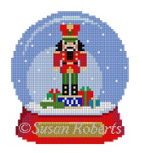 Susan Roberts needlepoint canvas shaped like a snowglobe with a nutcracker and presents inside