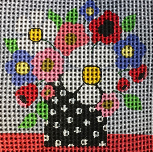 Amanda Lawford bright needlepoint canvas of a mod polka dot vase with daisies, poppies, and other flowers