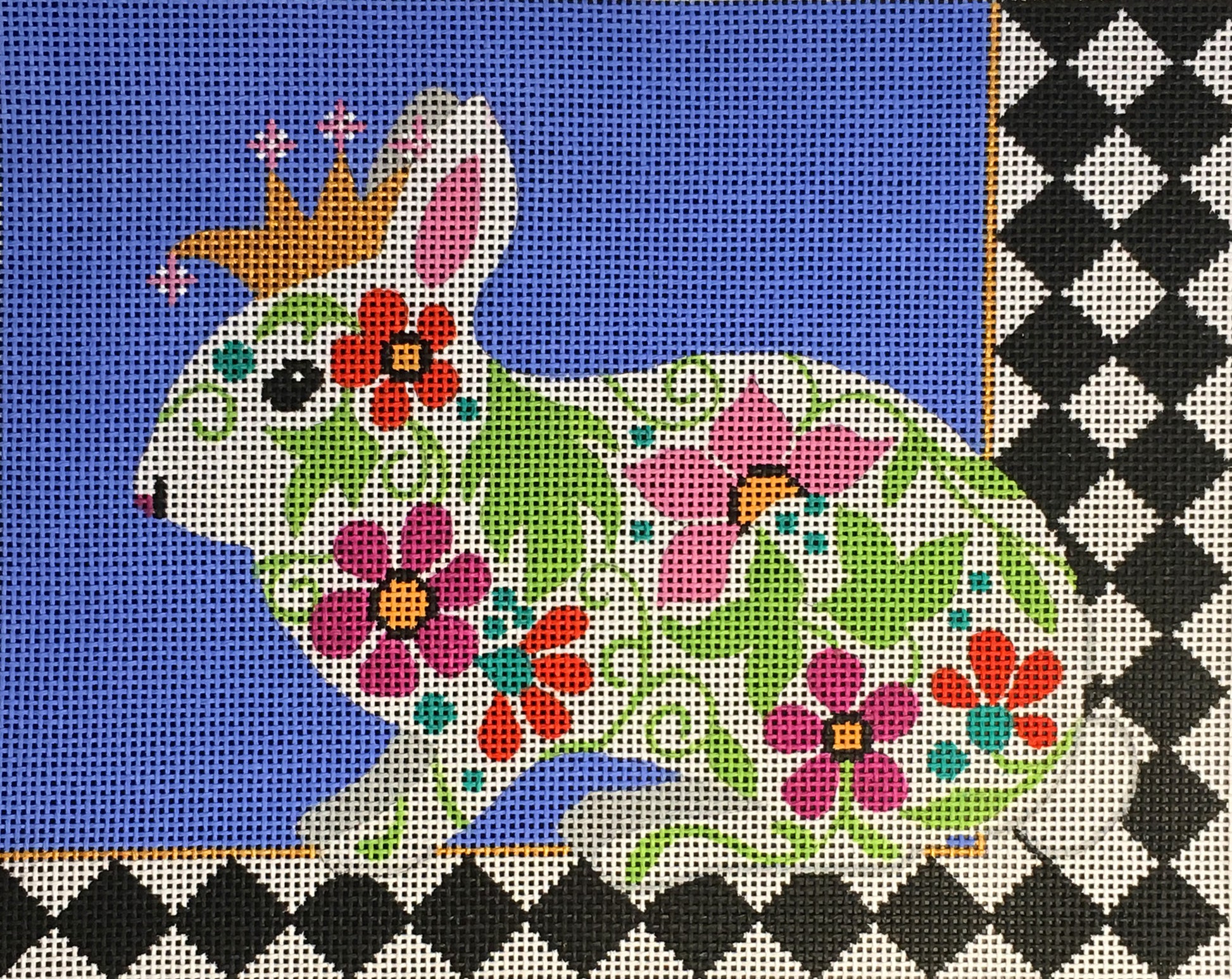 Amanda Lawford needlepoint canvas of a floral bunny rabbit wearing a crown with a bold black and white harlequin border