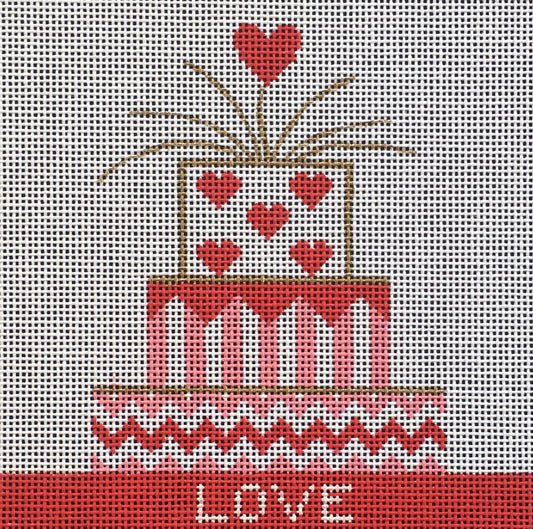 Vallerie Needlepoint Gallery needlepoint canvas of a three-tiered cake in pink white and red with a heart topper and the word love