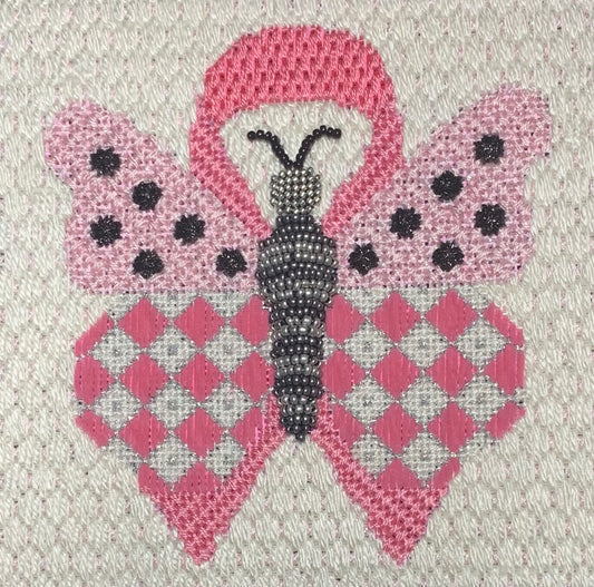 Stitched example of the butterfly for hope needlepoint canvas from Vallerie Needlepoint Gallery. The butterfly is pink with diamonds and polka dots and set over a breast cancer awareness ribbon