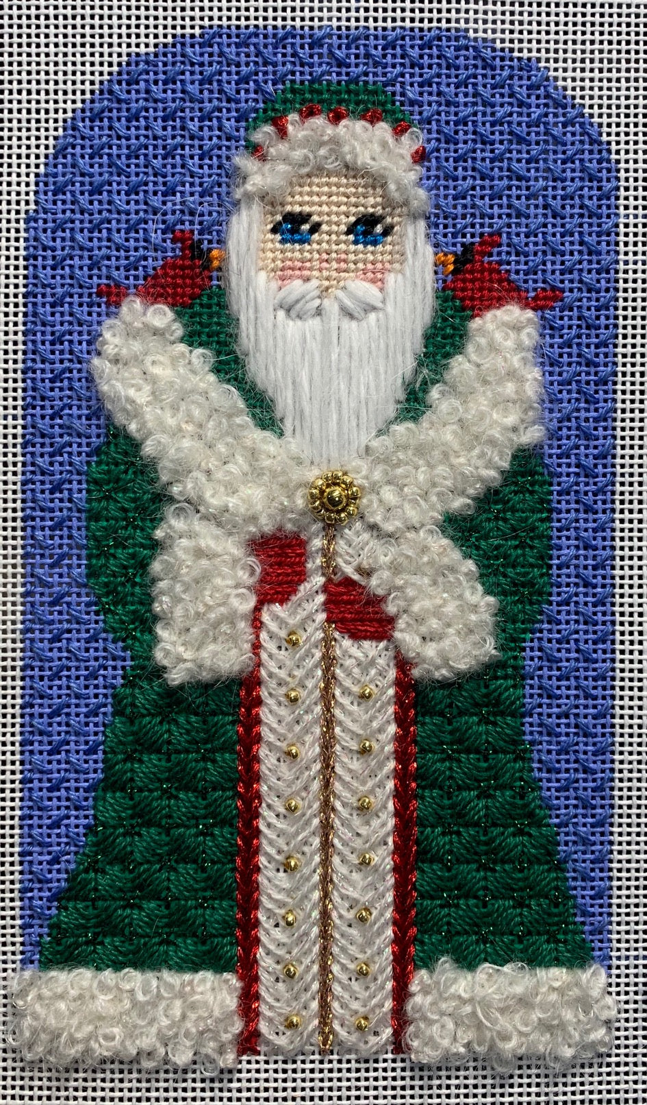 Stitched example of the Vallerie Needlepoint Gallery cardinal Santa with green coat with white fur trim