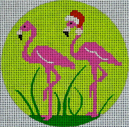 DC designs round Christmas ornament needlepoint canvas of two flamingos with a Santa hat on a tropical green background