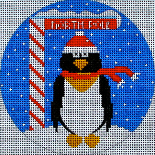 DC designs round Christmas ornament needlepoint canvas of a whimsical penguin wearing a scarf and a Santa hat at the north pole with a candy cane striped sign