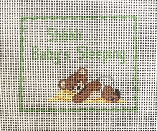 Susan Roberts needlepoint canvas of a sign for a baby or child's room that says "Shhhh..... Baby's Sleeping" with a teddy bear wearing a diaper and holding a blanket