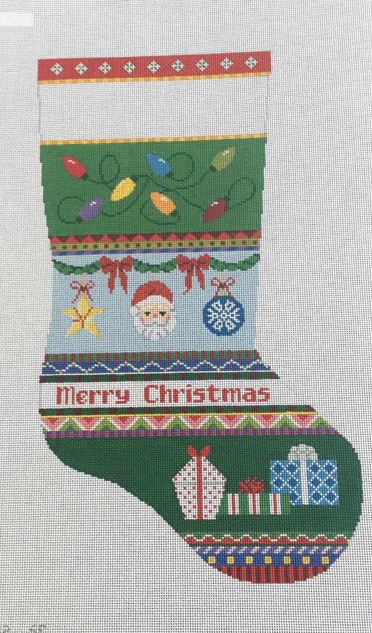 Susan Roberts needlepoint canvas Christmas stocking with bold stripes of lights, ornaments, and presents that says "Merry Christmas"