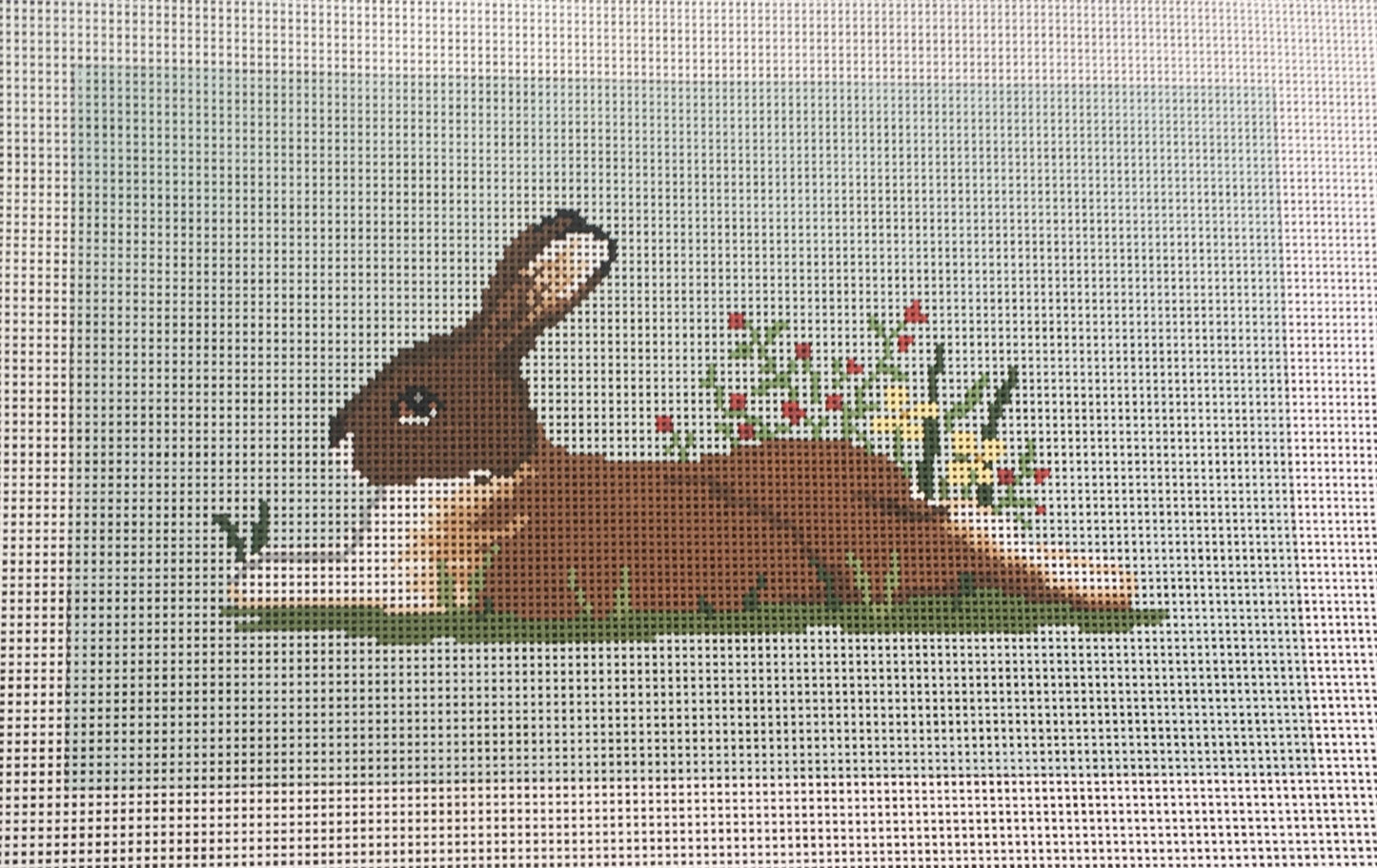 Susan Roberts needlepoint canvas of a resting bunny rabbit with flowers