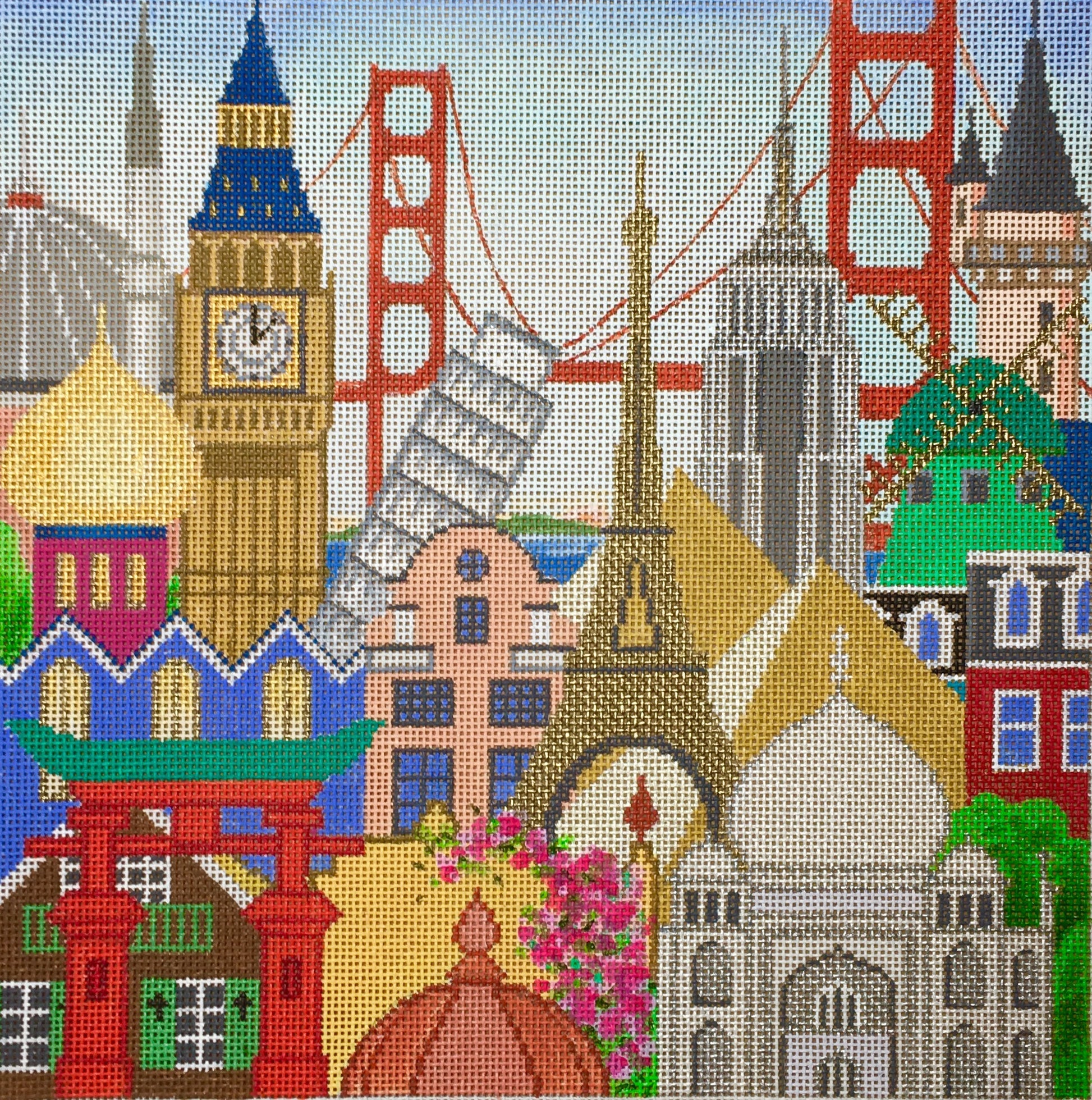 Amanda Lawford bright needlepoint canvas of famous world monuments in the same place (Big Ben, the leaning tower of Pisa, the Eiffel Tower, etc)