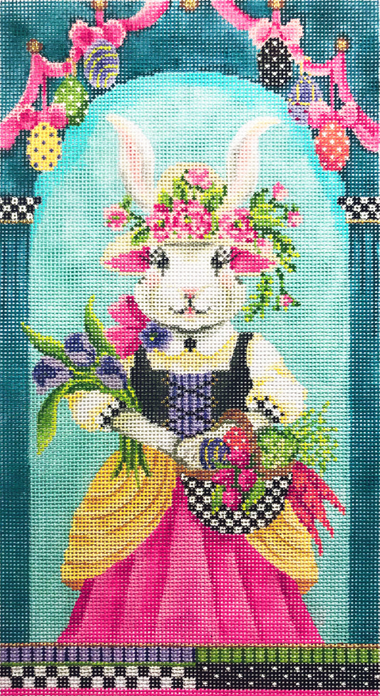 Kelly Clark needlepoint canvas of a white rabbit dressed in a victorian gown holding flowers surrounded by an archway with Easter eggs