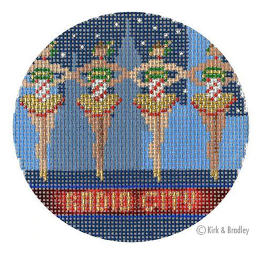 Kirk and Bradley ornament-sized needlepoint canvas of the Radio City Rockettes with the New York City skyline in the background. Part of a series of New York City holiday/Christmas canvases