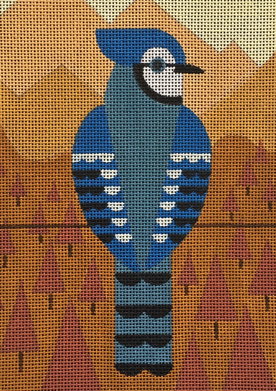 Scott Partridge needlepoint canvas of a geometric blue jay on a wire with orange geometric trees and mountains in the background for a fall and autumnal landscape