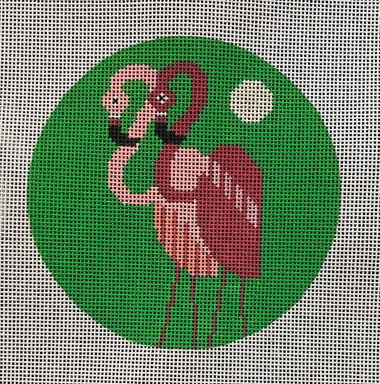 Scott Partridge round needlepoint canvas of two stylized and geometric tropical flamingos on a green background