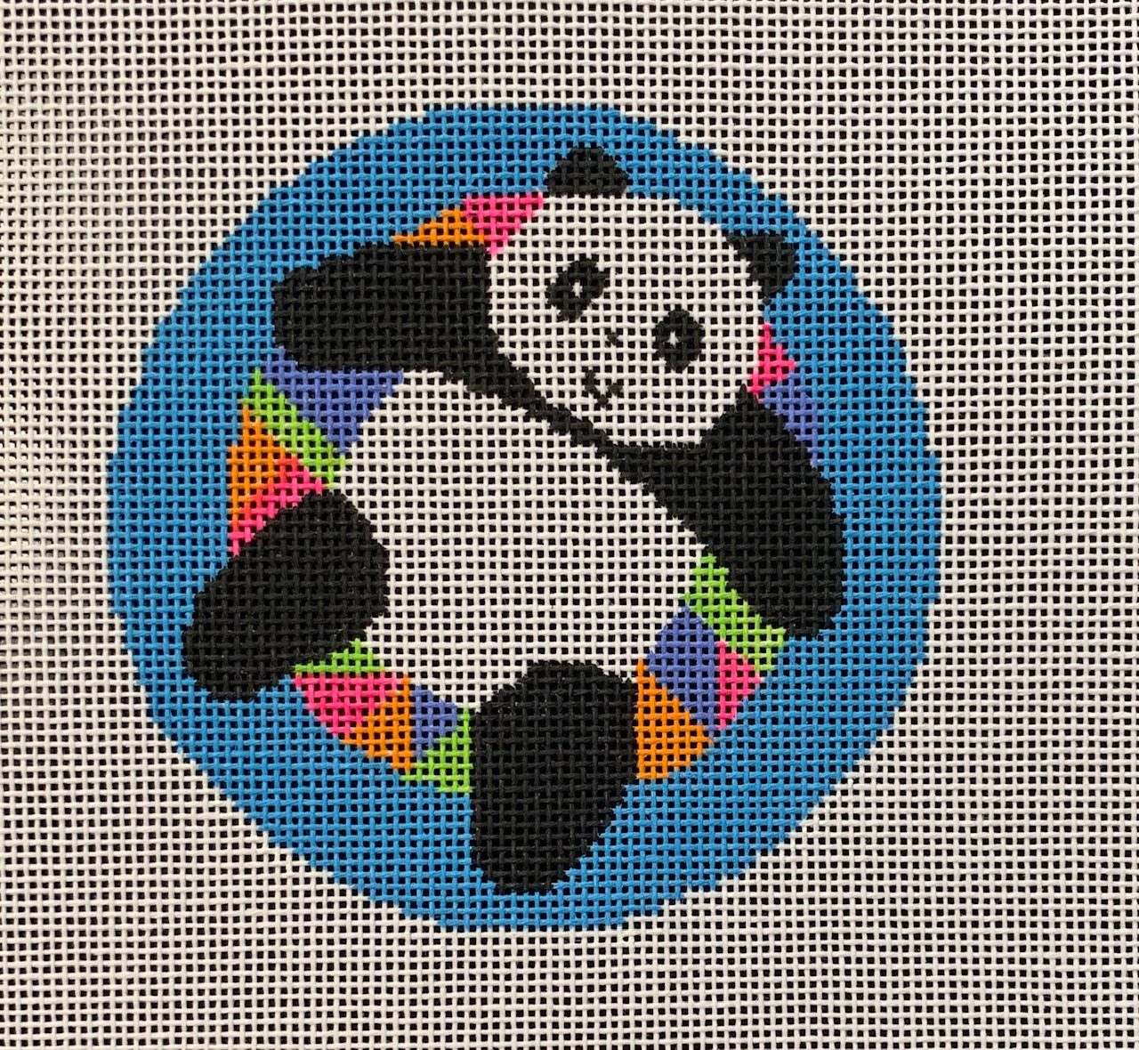 Vallerie Needlepoint Gallery round whimsical needlepoint canvas of a panda on a bright and vibrant floatie inner tube 