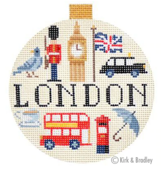 Kirk and Bradley ornament-sized round needlepoint canvas with a ball top (part of their travel round series) that says London and has iconic imagery of the city including a Beefeater, Big Ben, a double decker bus, a post box, a union jack, and a black taxi cab