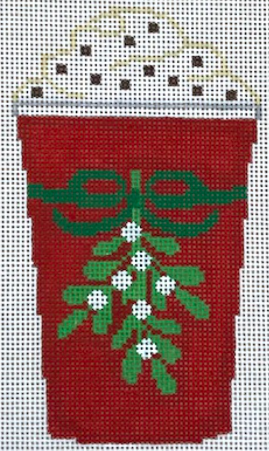 Rachel Donley needlepoint canvas of a red coffee cup with whipped cream tied with a green bow holding a sprig of mistletoe
