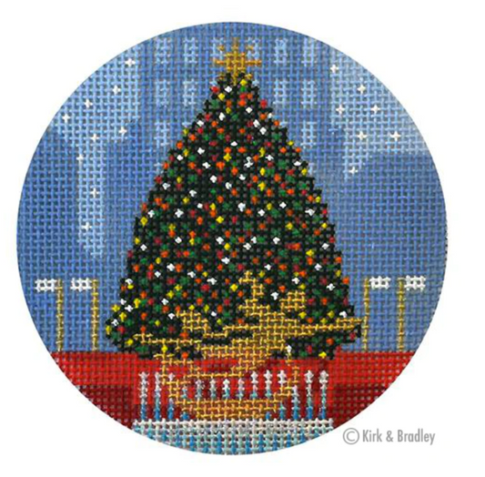 Kirk and Bradley ornament-sized needlepoint canvas of the Rockefeller Center christmas tree in New York City with the gold sculpture in front and skyline in the background