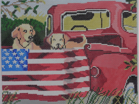 Birds of a Feather needlepoint canvas of two golden dogs in the back of a vintage red pickup truck with an American flag