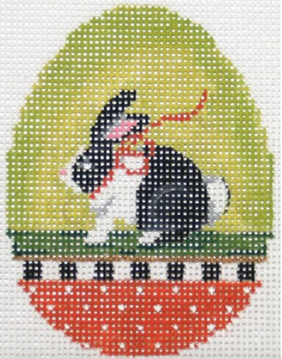 Kelly Clark Easter egg needlepoint canvas of a black and white bunny rabbit with a bow on a lime green background with a polka dot border