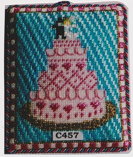 Princess and me needlepoint canvas with stitch guide of a wedding cake with a bride and groom topper