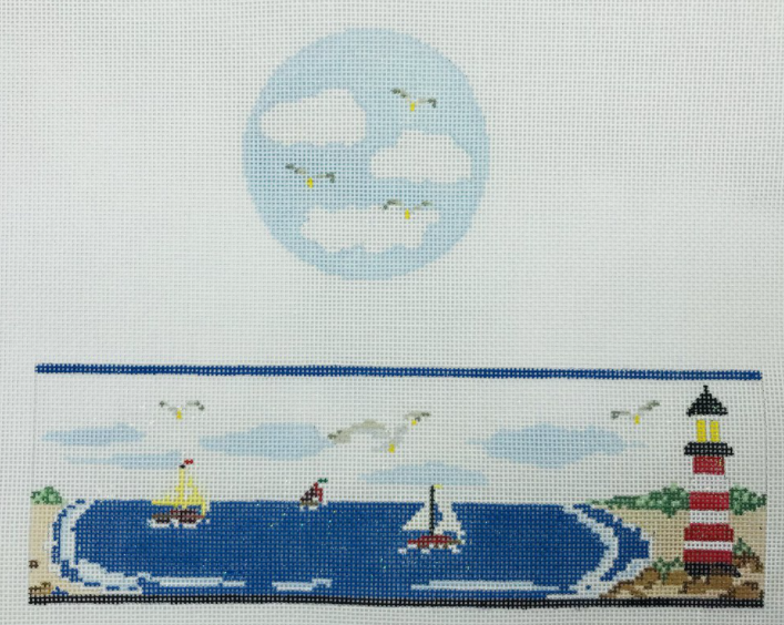 Funda Scully needlepoint canvas for a round hinged box of a seaside landscape with a lighthouse, sailboats, and sea gulls