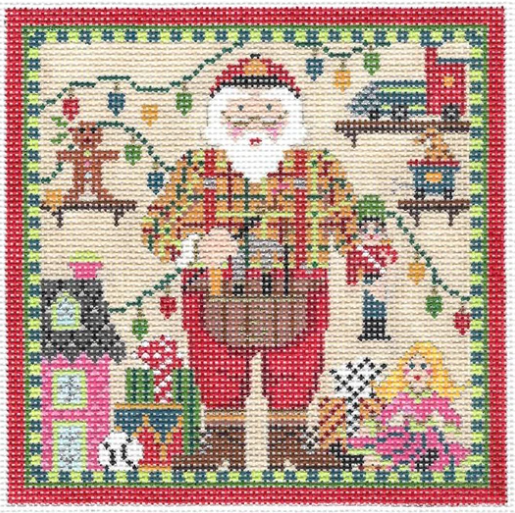 Kelly Clark needlepoint canvas of a Santa Claus in his workshop holding a toy soldier with presents in the background