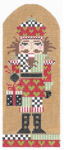Kelly Clark Christmas needlepoint canvas of a nutcracker patterned with hearts holding a present