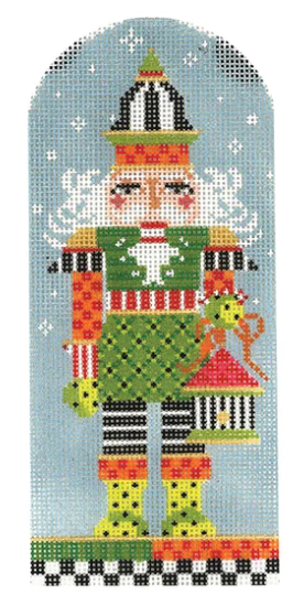 Kelly Clark needlepoint canvas of a Christmas nutcracker holding a birdhouse in the snow