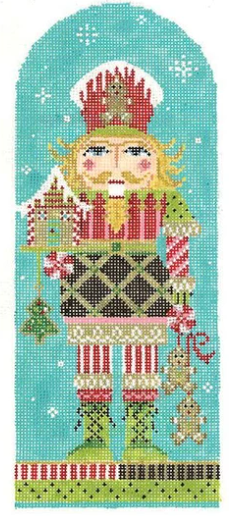Kelly Clark Christmas needlepoint canvas of a nutcracker chef holding a gingerbread house and gingerbread men in the snow