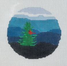 Blue Ridge Stitchery round needlepoint canvas of a cardinal in an evergreen pine tree with blue rolling hills in the background
