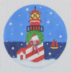 Pepperberry round needlepoint canvas of a lighthouse with a wreath decorated for Christmas with snow and a sailboat in the background